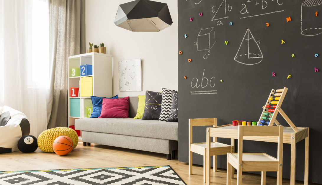 Kids play-room decorated with a chalkboard wall and lot's of storage for toys