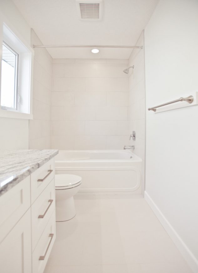 Full bathroom renovation with white finishes