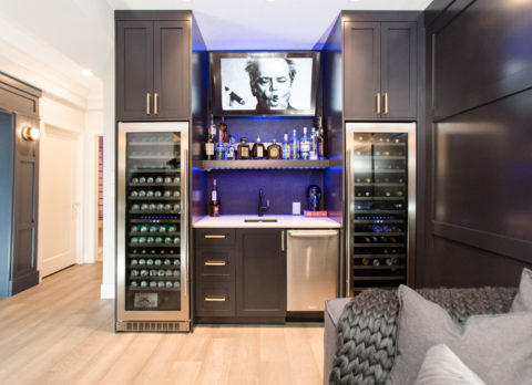 Newly renovated basement with wet bar that has two full-sized wine fridges