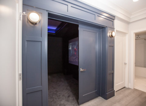 Double french doors create an impressive entry way to the home theatre