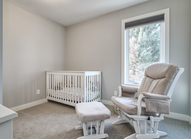 This full home renovation included this adorable nursery with large triple pane window.