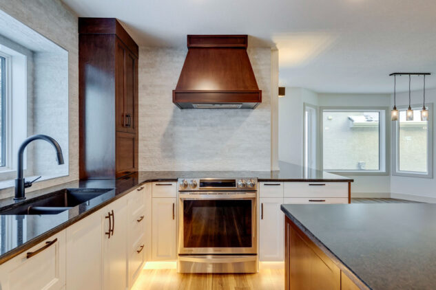 Kitchen with white cabinetry and stained wood cabinetry