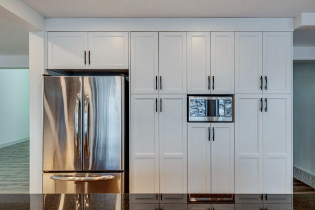 White cabinetry with fridge