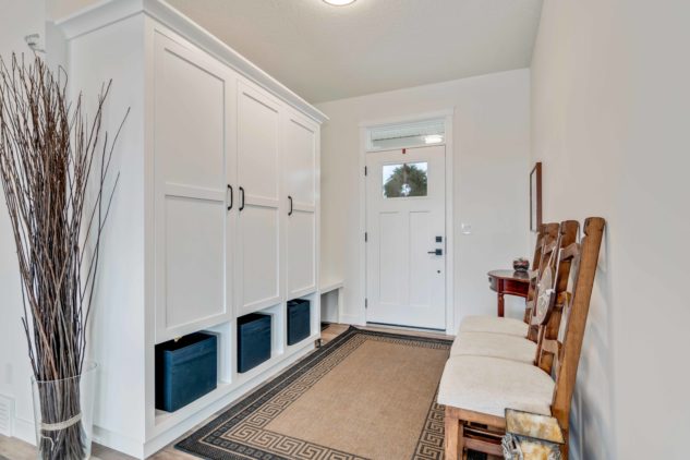 Large mudroom with custom cabinetry for storage