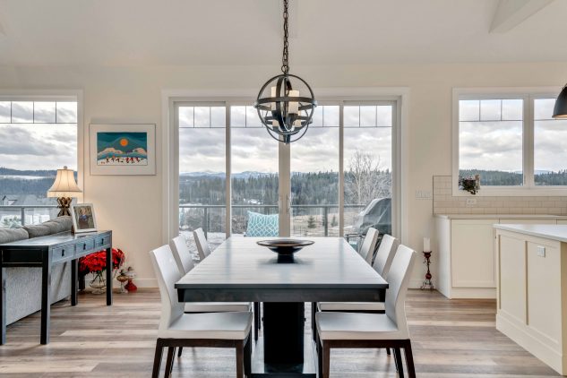 A modern dining area with a large window for a view of the countryside