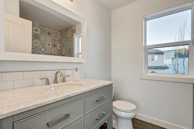 This large bathroom was custom built with gorgeous grey cabinets
