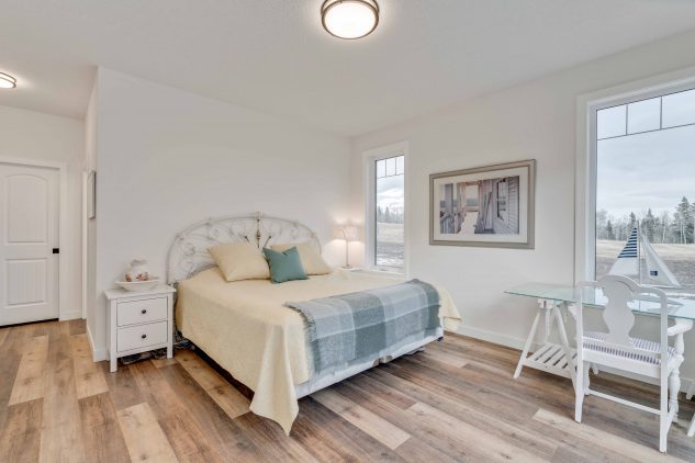 Large master bedroom in a custom acreage bungalow new home build