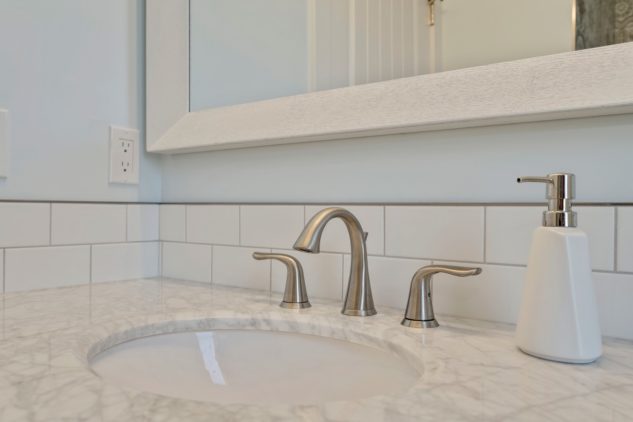 Custom sink with tile backsplash and marble countertop