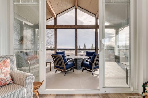 This three-season room or sunroom completes this gorgeous new home construction in the country