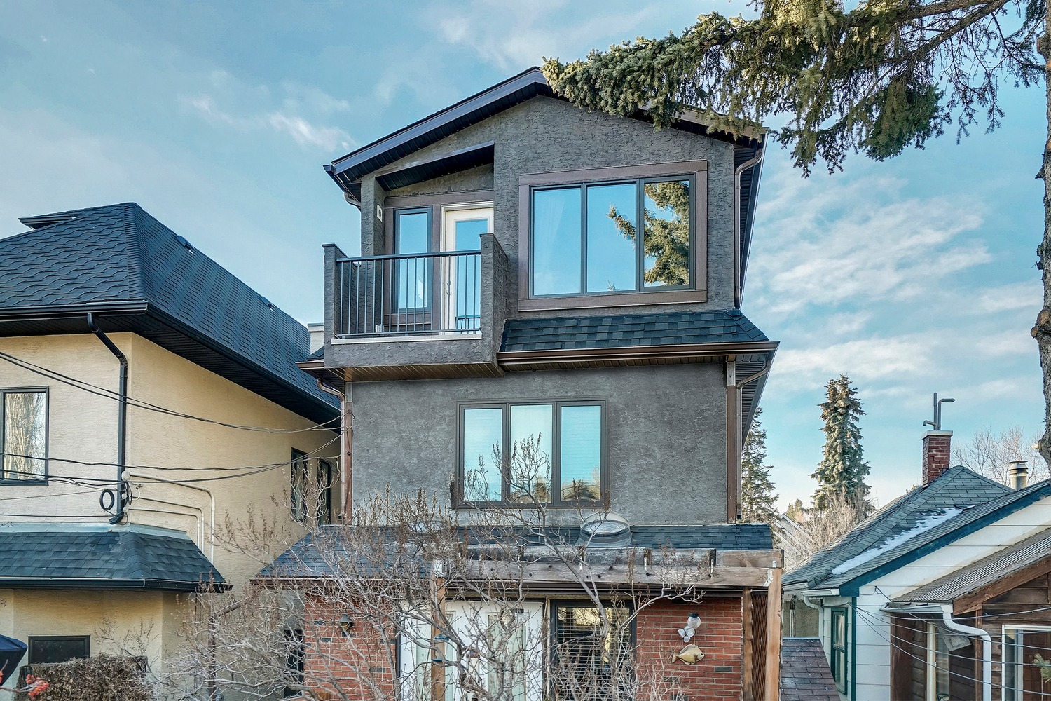 The Exterior of a 3-storey Calgary home with a balcony off of the Master Bedroom