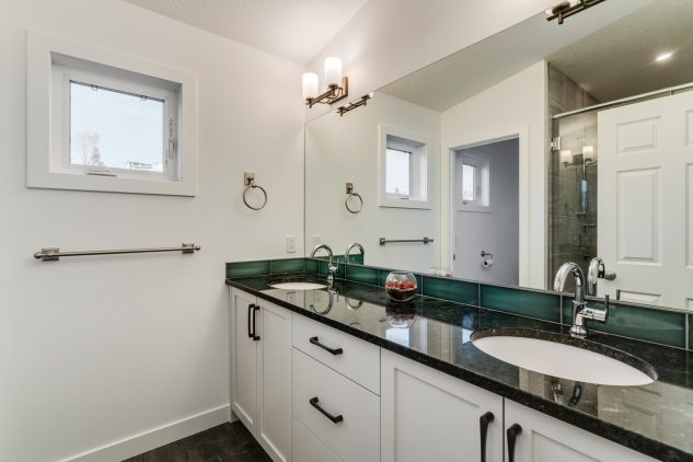 This master ensuite with dual sinks is part of the new third storey in this Calgary home