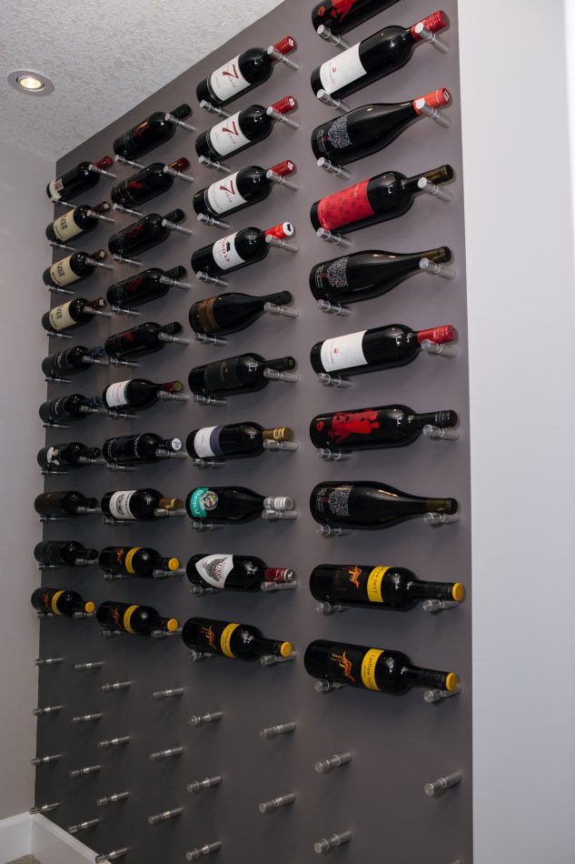 Wine wall with wine pegs in basement development