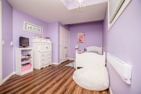 Kids bedroom with LVP flooring in basement development