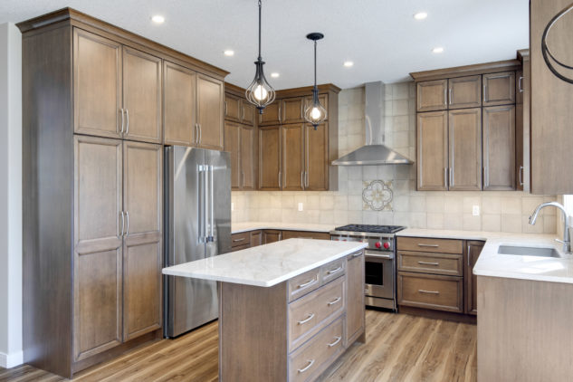 Stained maple kitchen cabinetry with small island