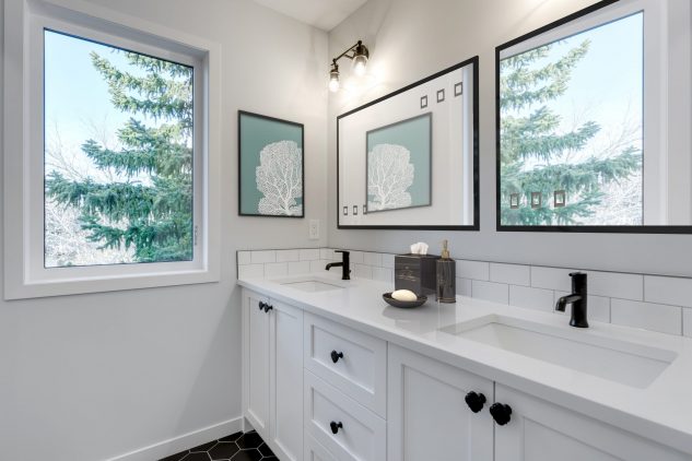 Main bathroom with white cabinets and white quartz countertops 