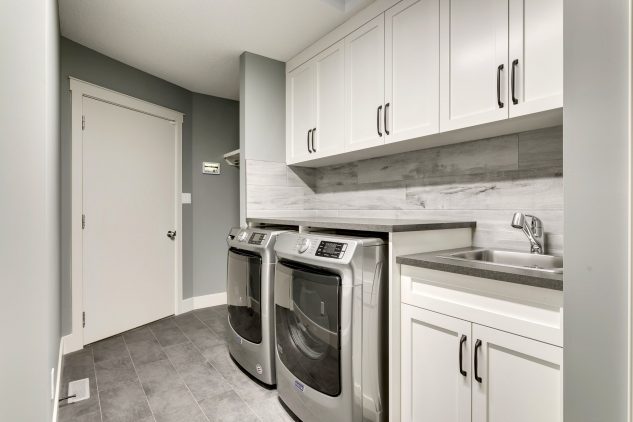 Laundry room with custom cabinets and mud room built-in