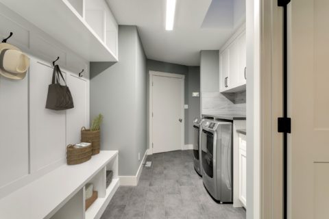 Laundry room with custom cabinets and mud room built-in