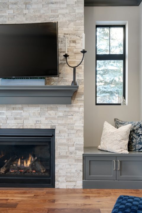 Stone fireplace with custom built-in benches and mantle