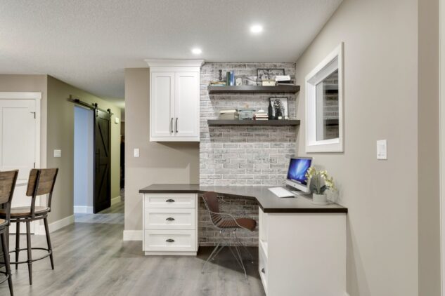 Custom desk with floating shelves and brick wall