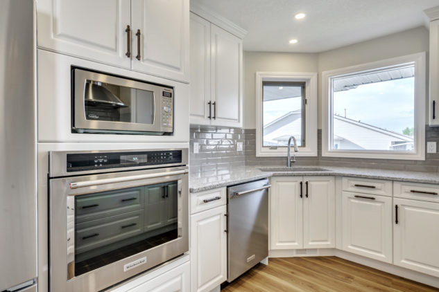 Custom white cabinetry with wall oven