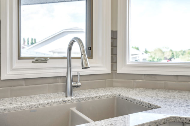 Kitchen sink with quartz countertops and stainless steel faucet