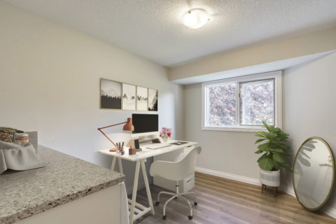 Office desk in laundry room with quartz countertops. LVP Flooring