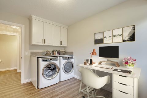 Laundry room with custom cabinetry and office desk. LVP Flooring