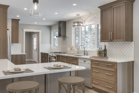 Maple stained cabinetry, white quartz countertops and tiled backsplash.