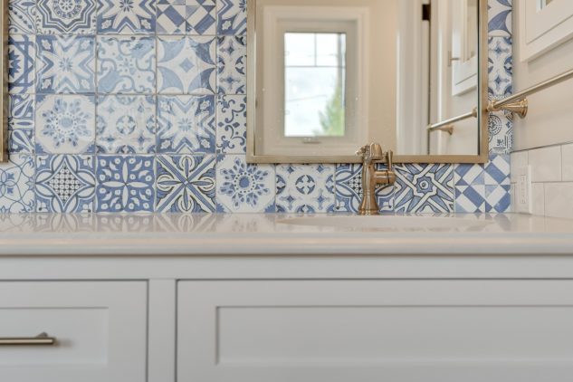 Mediterranean Ensuite Renovation with blue hand painted tile and champagne bronze plumbing fixtures