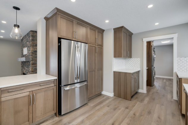 Maple stained cabinetry, white quartz countertops.
