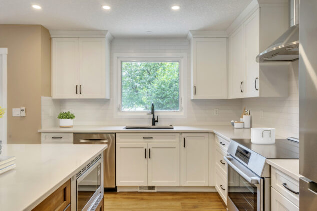 Stained kitchen island with white perimeter cabinetry. 
