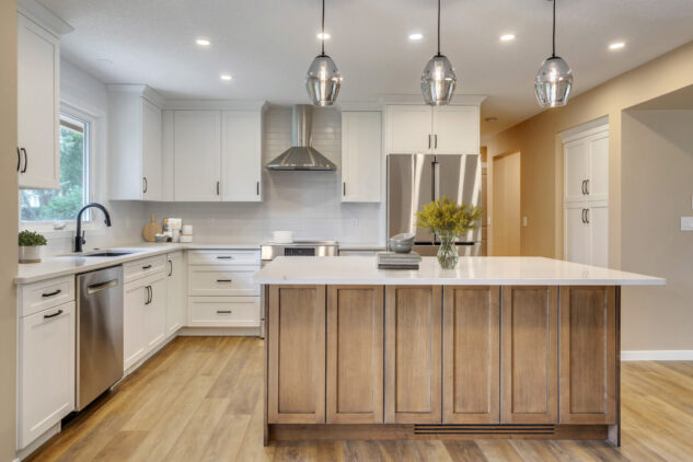 Stained kitchen island with white perimeter cabinetry.
