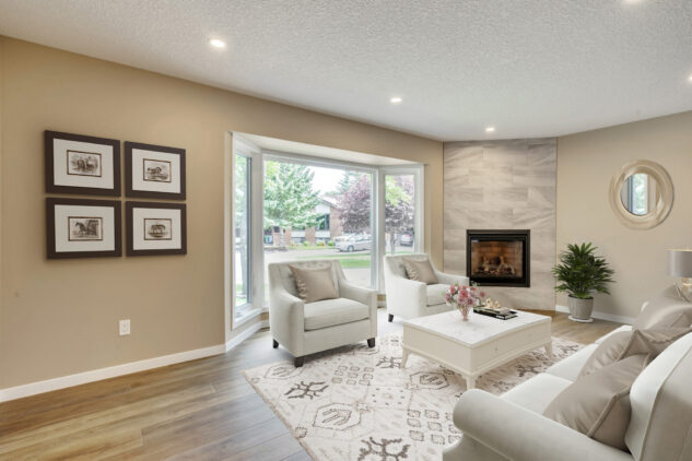 Living room with tiled gas fireplace.
