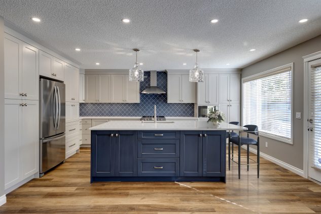 kitchen with large blue island and custom cabinetry