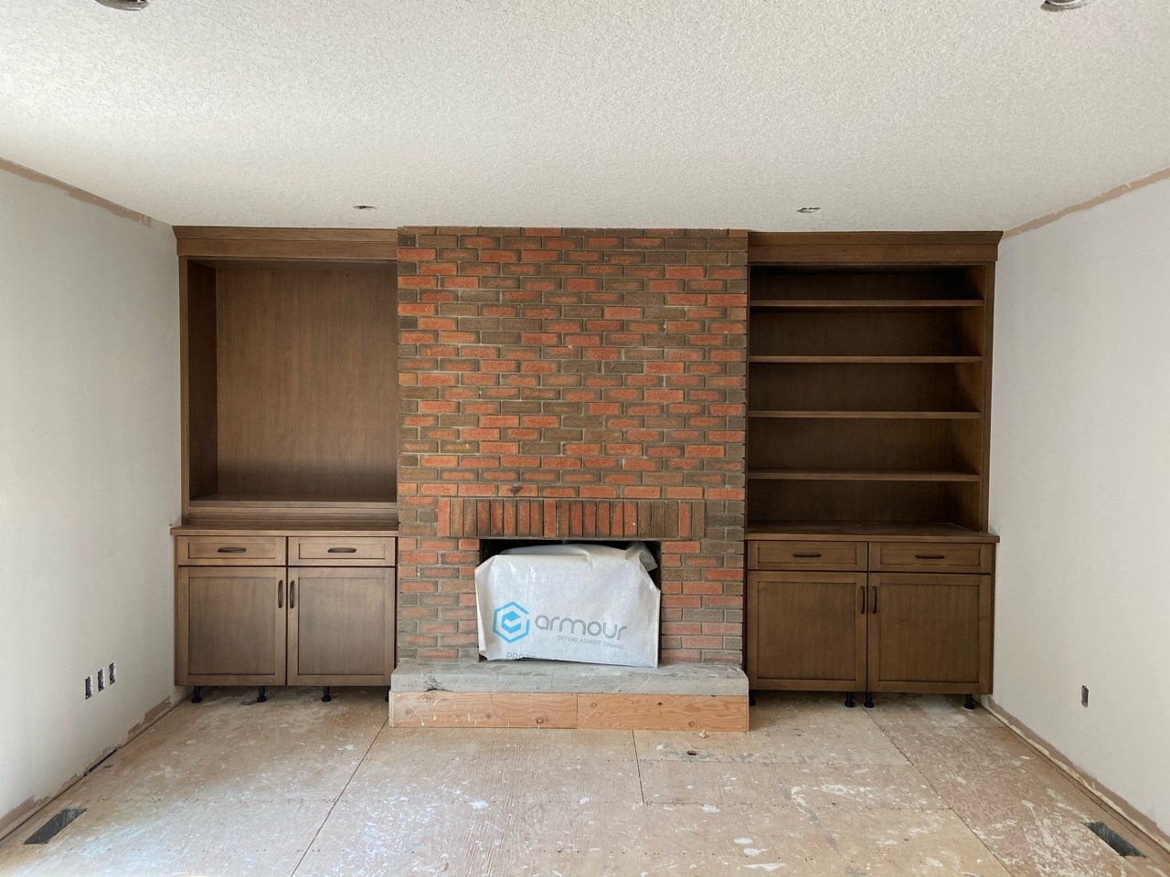 old fireplace with broken shelves on each side