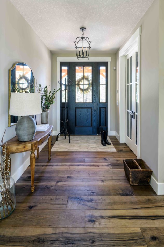 Front foyer with wide plank hardwood and tile in-lay