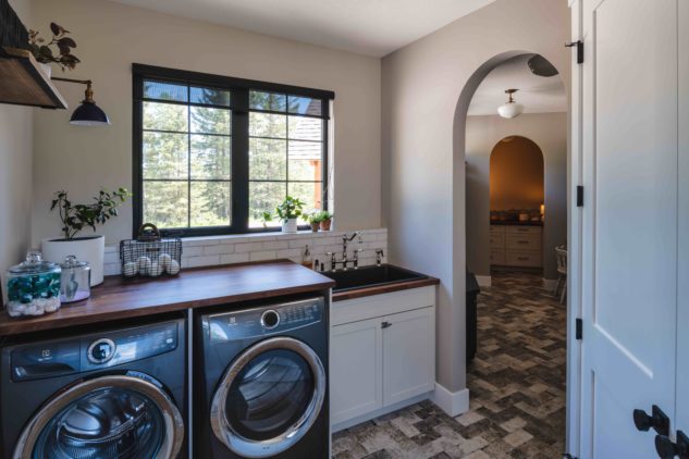 Laundry room with sink and wood countertops