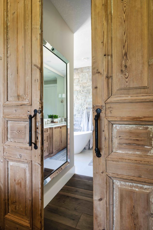 Antique French rustic barn doors for entry to ensuite bathroom