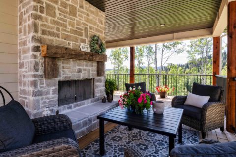 Outdoor wood burning fireplace with stone facade