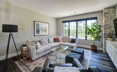 Basement living room with large black aluminum clad windows