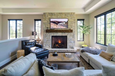 Old world stone fireplace with restored beam mantle 