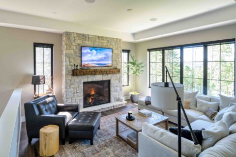 Living room with custom stonework and 42