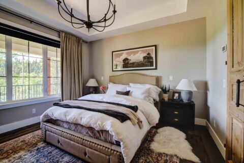 Primary farmhouse bedroom with tray ceiling detail