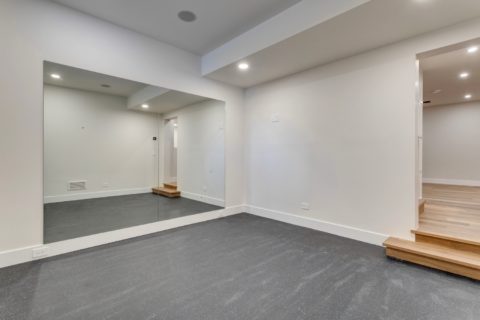 Calgary, Alberta custom home builder. Gym with rubber floors and 10mm glass. 