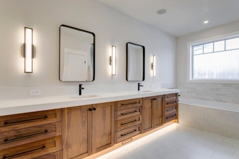 Ensuite with custom walnut vanity and 3