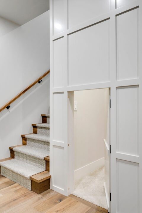 Calgary infill custom home builder. Kid's cubby inside a panelled wall with a hidden door 