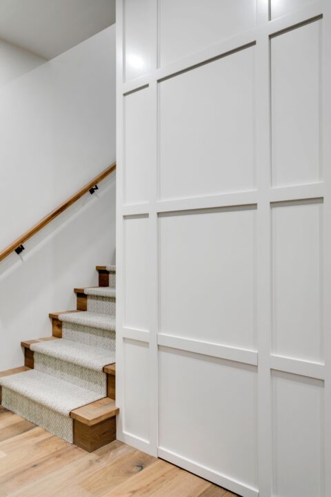 Calgary infill custom home builder. Kid's cubby inside a panelled wall with a hidden door 