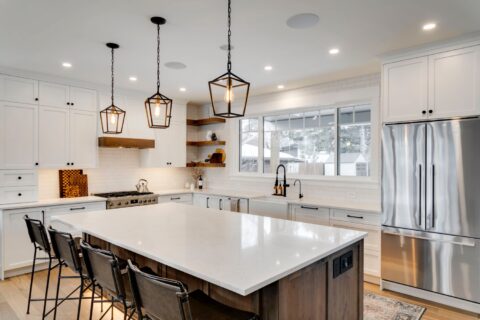 Calgary infill custom home builder. White paint-grade kitchen with knotty maple island. Floating shelves, pendant lights, full height subway tile backsplash.  Modern farmhouse.