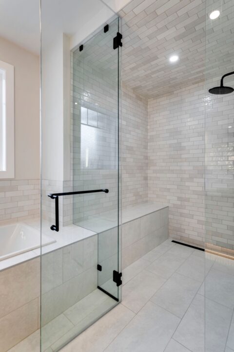 Custom infill home in Calgary, Alberta. Tiled steam shower with 10mm glass and black hardware