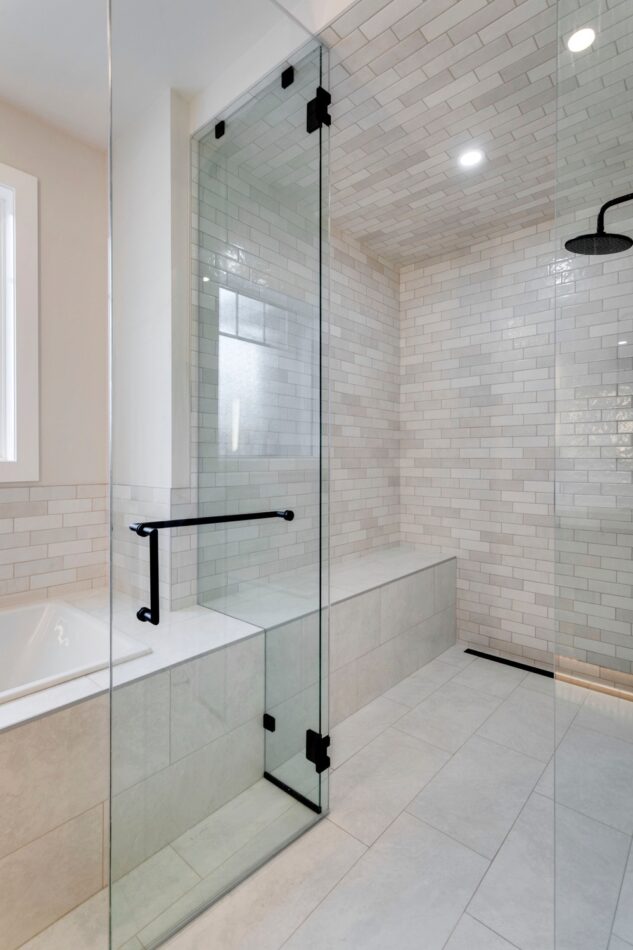 Custom infill home in Calgary, Alberta. Tiled steam shower with 10mm glass and black hardware